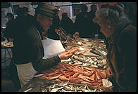 Fishmonger and customer in Venice's Rialto Markets