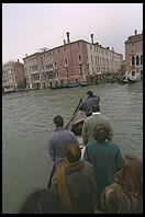 People standing up in the Traghetto Gondola, a micro-ferry service that crosses the Grand Canal at seven points.  These cost about 50 cents and hence are by far the cheapest way to get a gondola ride.  You're a sissy if you sit down.