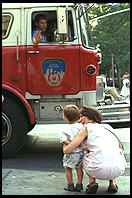 Kid and fire engine.  Outside French Roast, 6th Avenue and 11th, Manhattan 1995.